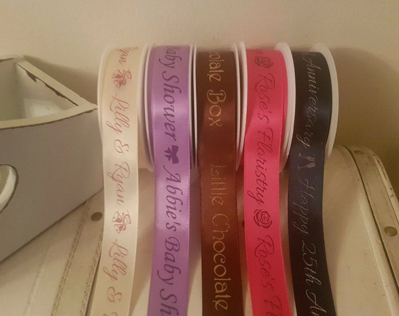 Personalized satin ribbon rolls with printed logos and wording in multiple colors