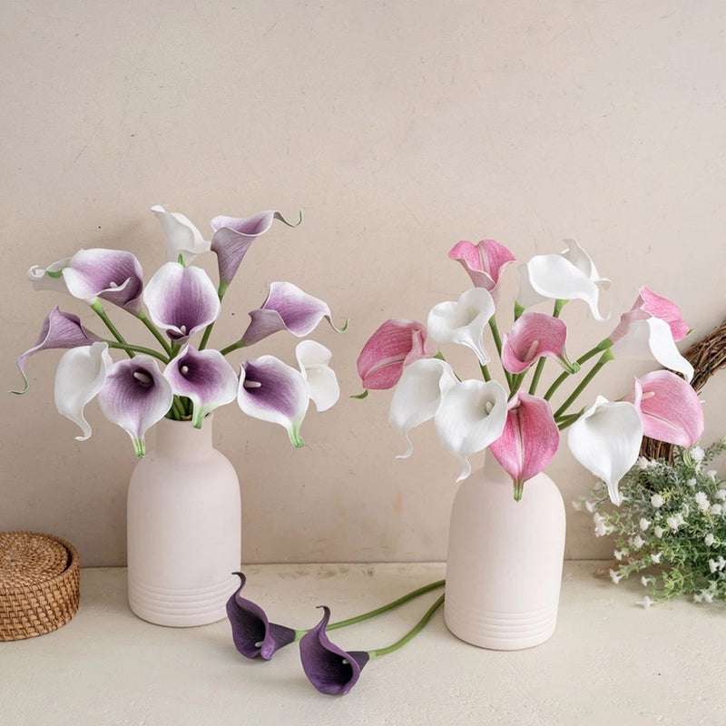 Set of artificial calla lily bouquet flowers in white pots, purple and pink blooms