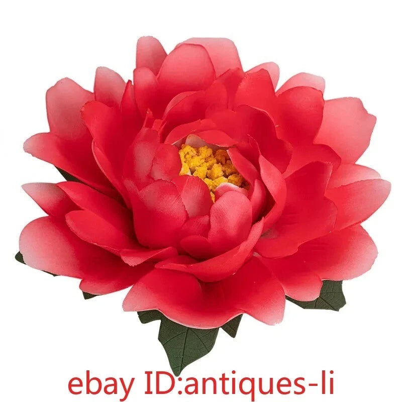Red ceramic peony flower statue with yellow center and green leaves