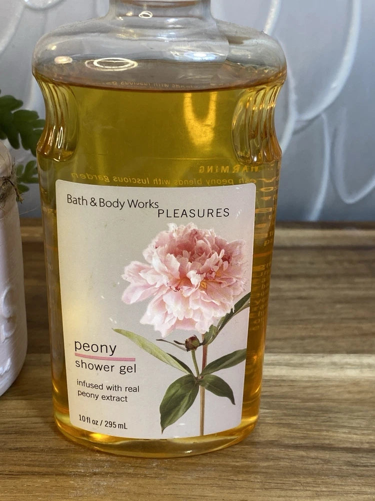 Bath & Body Works Pleasures peony shower gel bottle, 10 fl oz, golden liquid with label