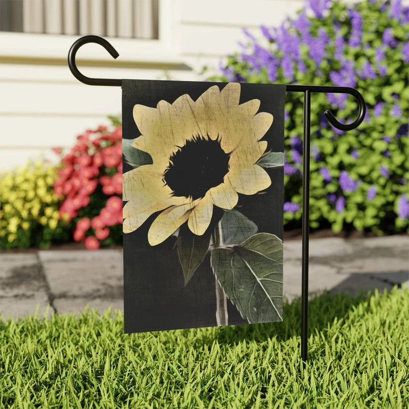 Black outdoor garden flag with large sunflower print and metal hanging rings