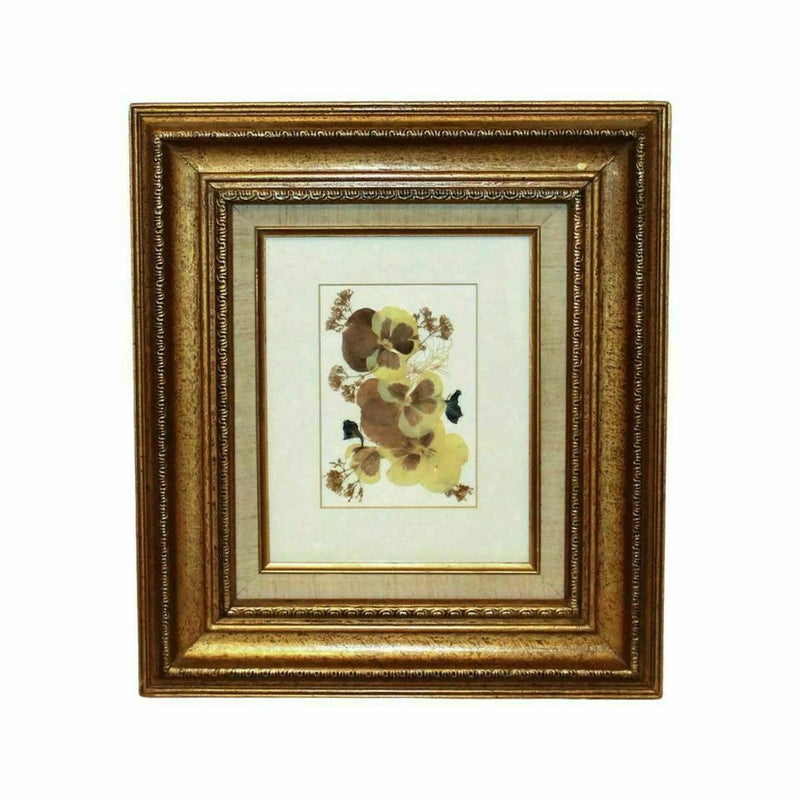 Framed pressed flower wall art with ornate gold frame and matted dried blossoms