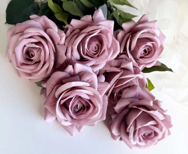 Dusty pink faux rose stem flowers with green leaves, bundle of blooming roses
