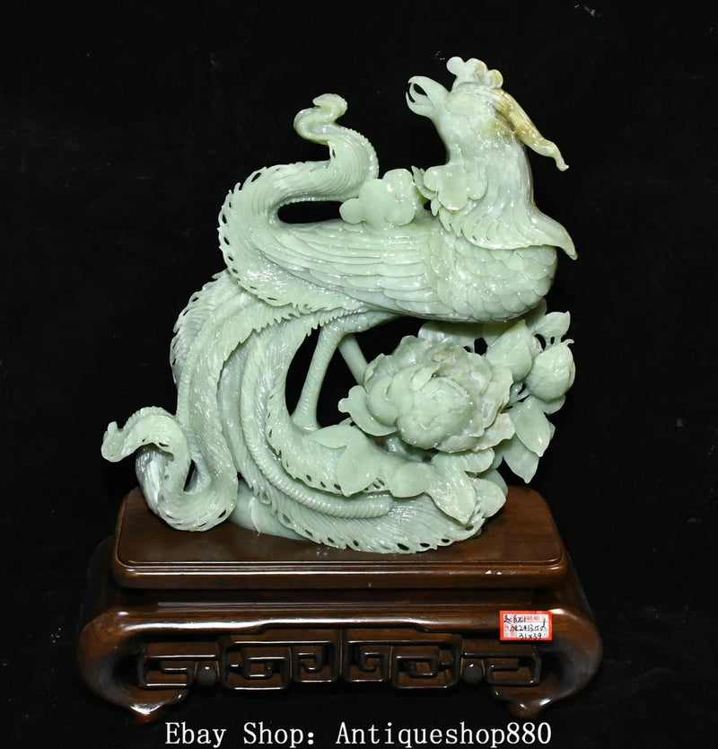 Light green jade carving phoenix statue with swirling wings on wooden display base