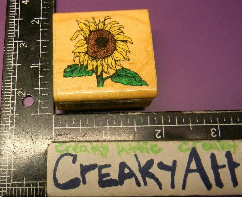 Small wooden rubber stamp with sunflower, stem, and green leaves design