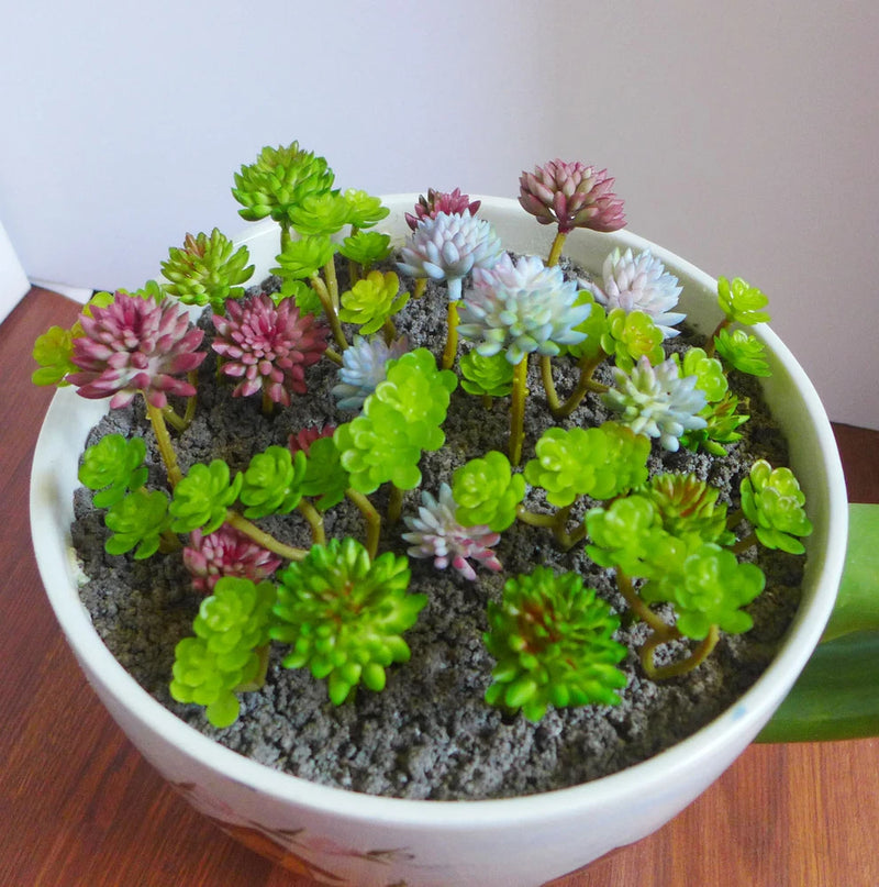 Miniature artificial succulents set in white planter bowl with mixed green and pink rosette stems