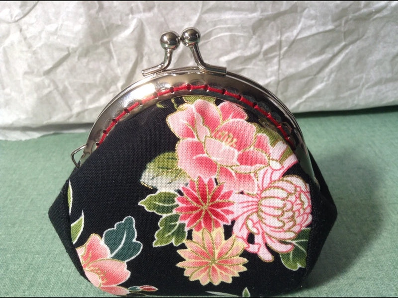 Peony kiss-lock coin purse with black fabric, pink floral fan pattern, and metal clasp