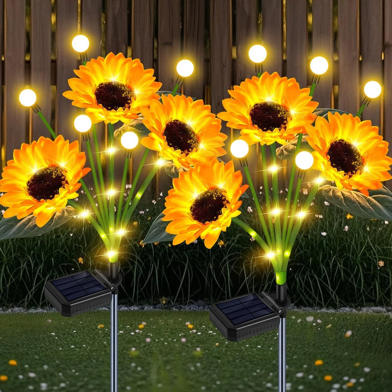 Solar sunflower garden lights: yellow blooms on stakes with glowing bulbs and solar panels