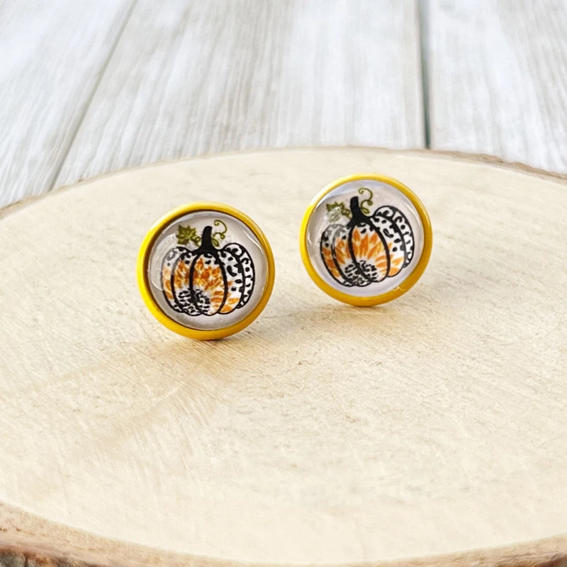 Yellow enamel round stud earrings with pumpkin illustration, stainless steel post