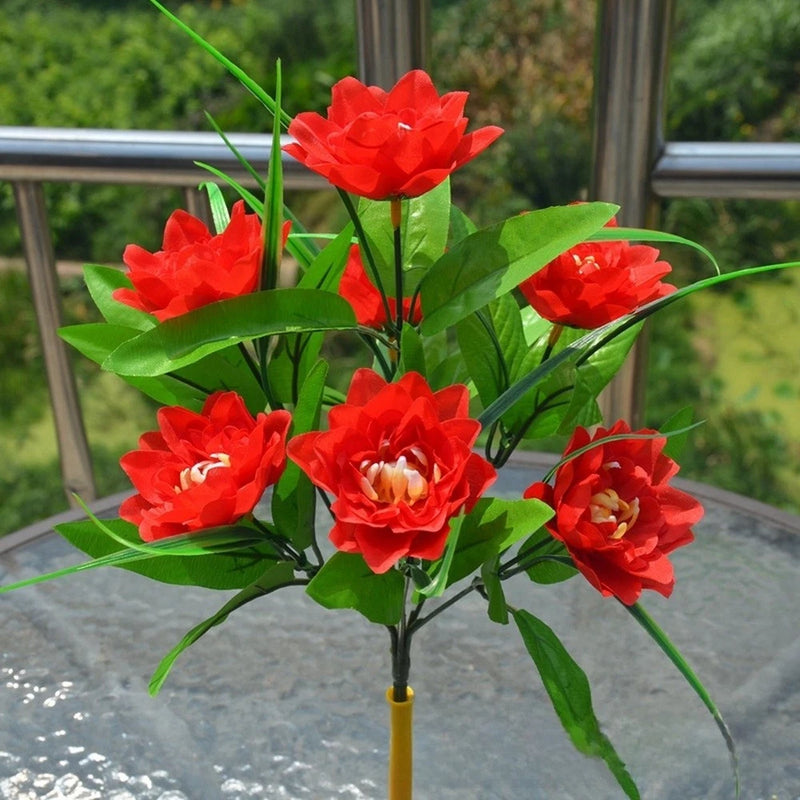 Artificial silk peony bouquet with red full blooms and green leaves on a stem