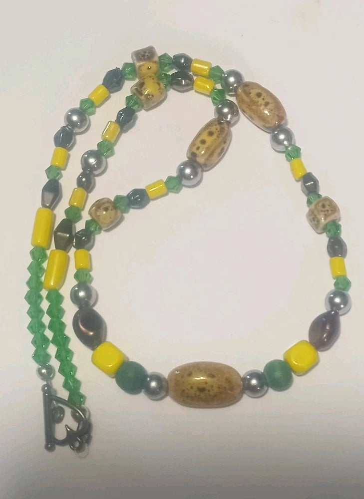 Sunflower beaded necklace with green, yellow, and brown beads and dangling charm