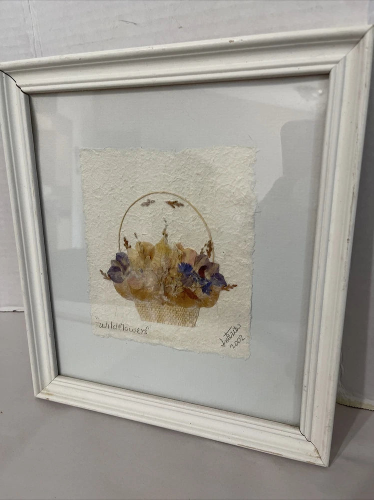 Framed pressed dried flower wall art with beige mat, yellow and purple wildflowers, circular layout