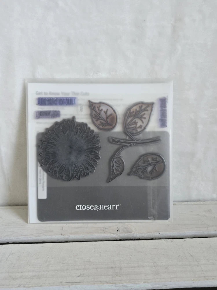 Close to my Heart acrylic stamp set with sunflower and leaf designs in clear packaging