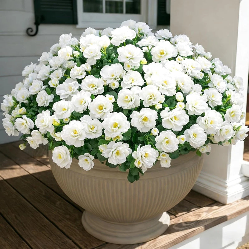 Artificial white flower plant with green leaves, round in white urn-style planter
