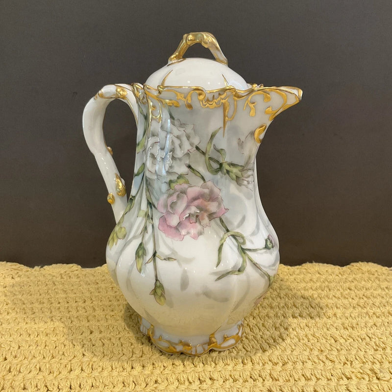 Antique white porcelain tea pitcher with gold trim, pink carnation floral pattern, lid