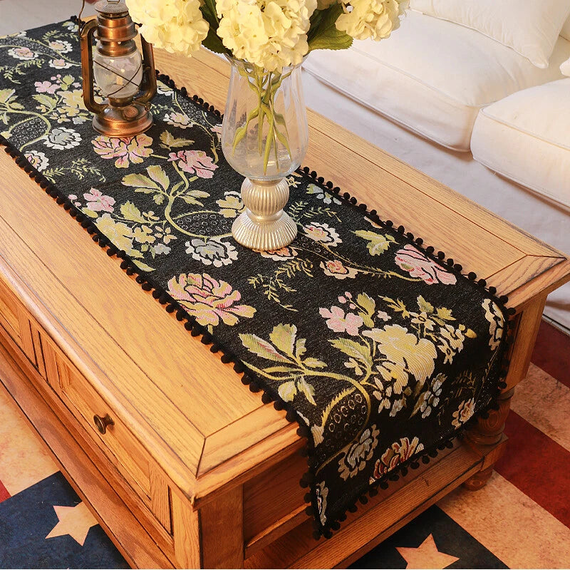 Black floral jacquard table runner with beaded ball fringe border
