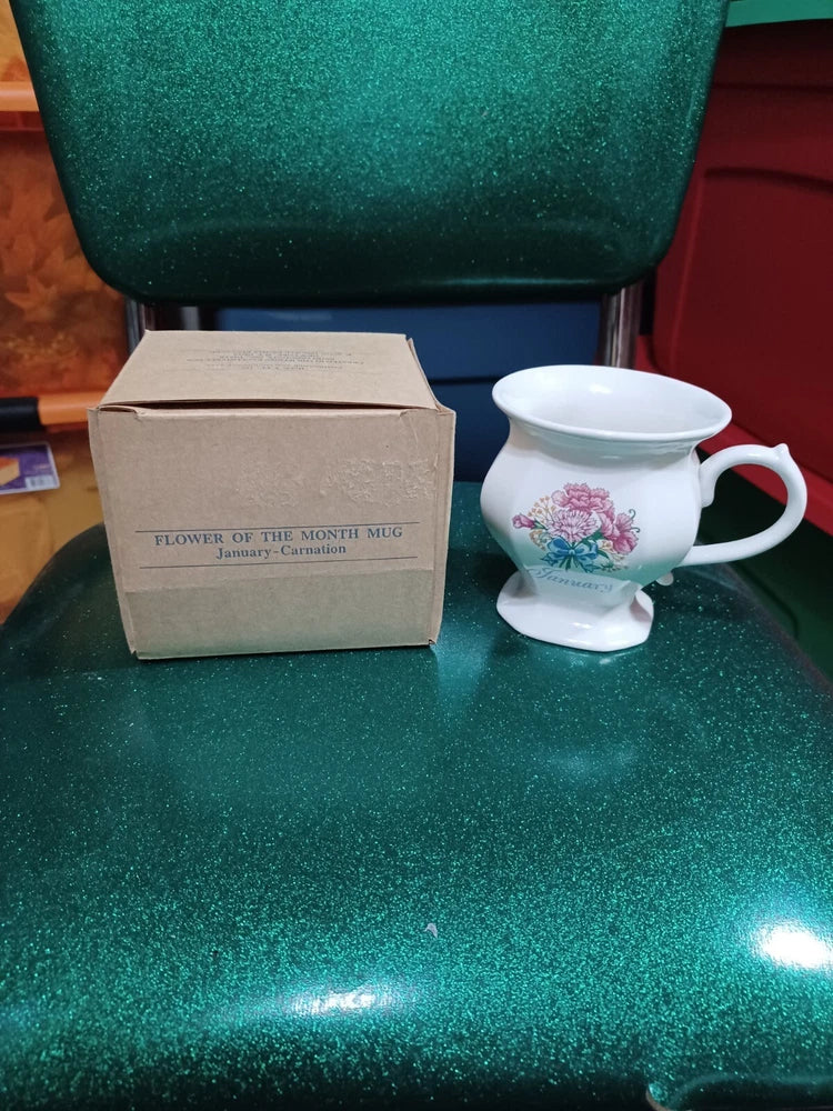White floral Avon Flower of the Month mug with pink carnation design and handle