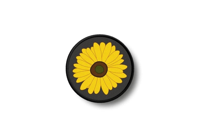 Round black iron-on sunflower patch with bright yellow flower and brown center.