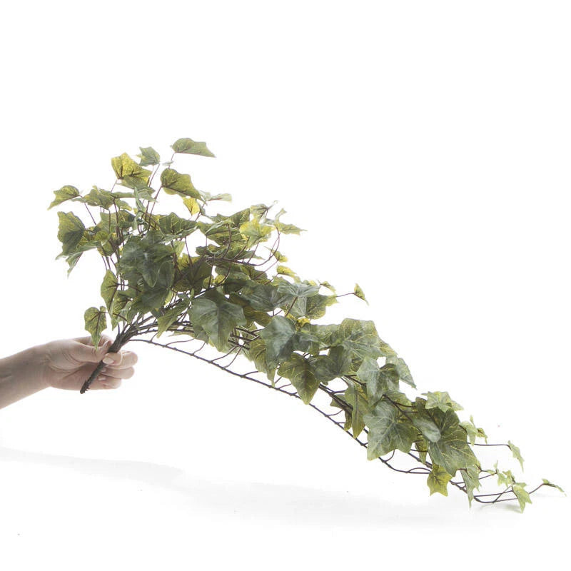 Artificial cascading ivy bush with green clustered leaves, held in a hand