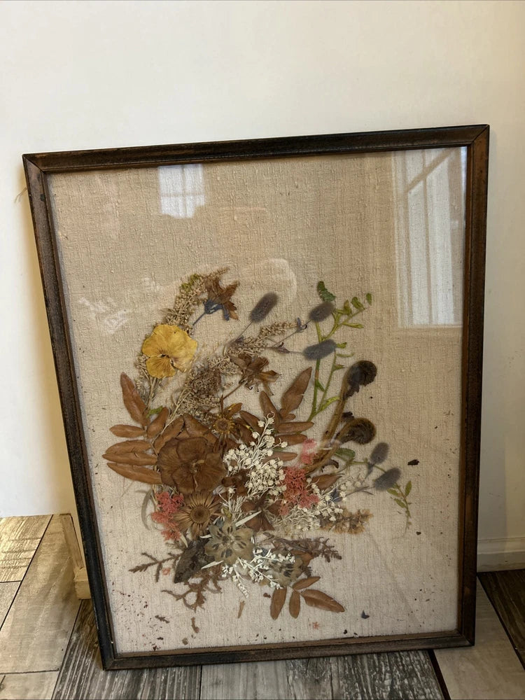 Framed pressed flower wall decor with dried botanicals and brown dark frame