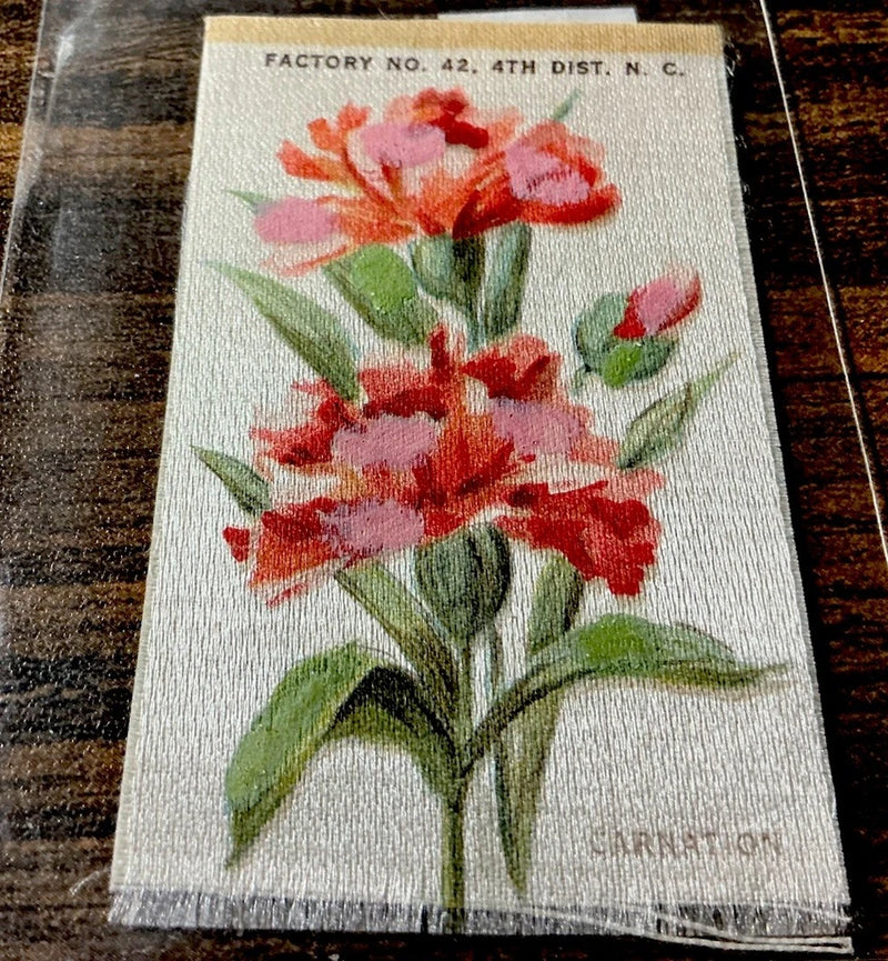 Carnation silk cigarette card with backing, red and pink flowers on light fabric