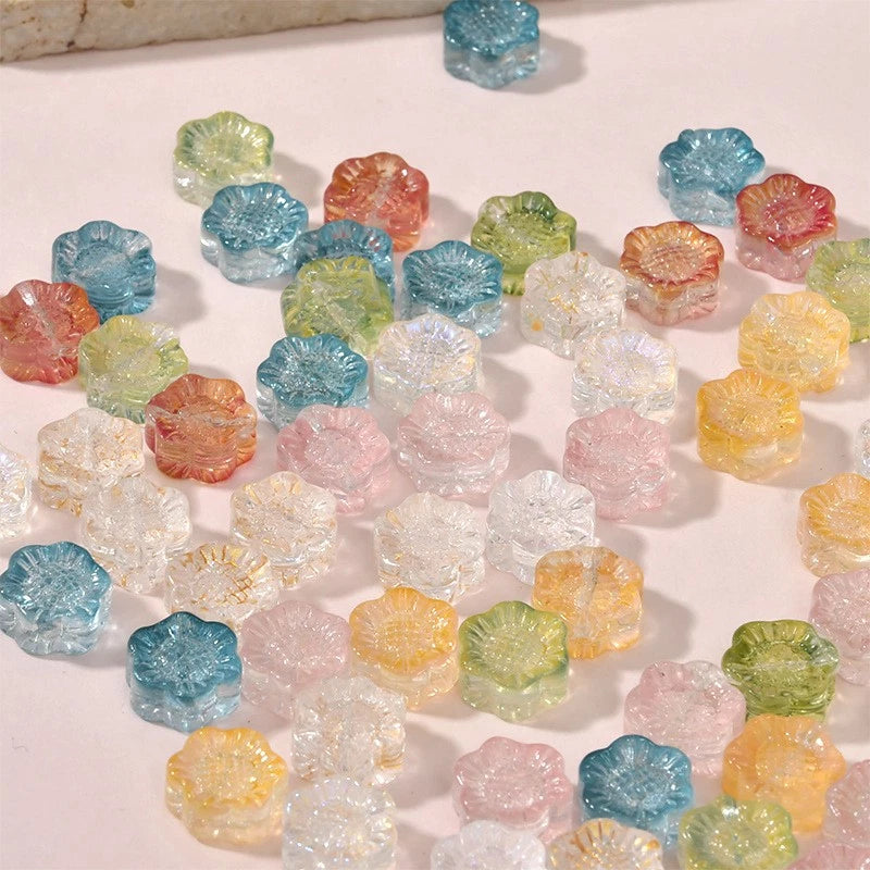 Handmade lampwork glass sunflower spacer beads, assorted pastel colors, for jewelry making.