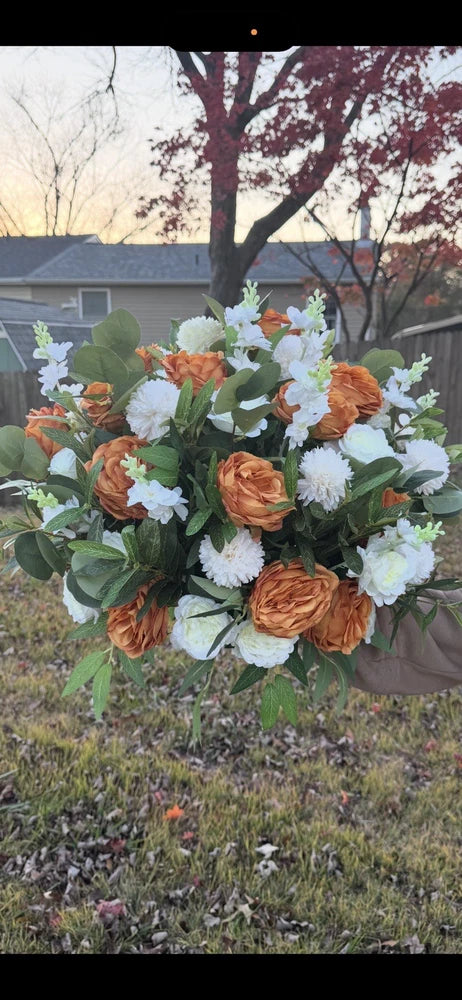 Artificial flower bundle: fabric roses and carnations in orange and white with green leaves