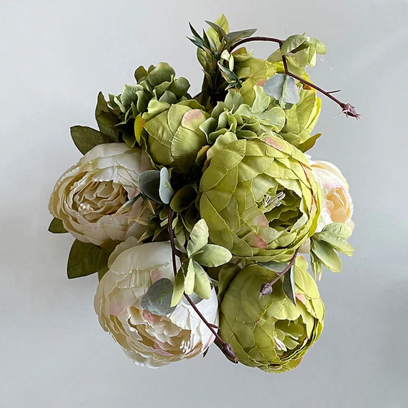 Artificial peony flower bouquet with green and cream blooms and leafy stems