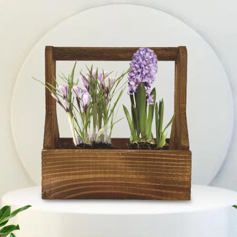 Wooden planter box with soil and purple and white flowers