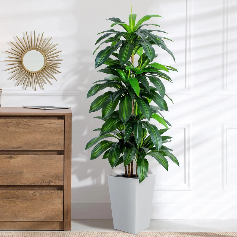 Artificial dracaena tree with green leaves in a white tall planter