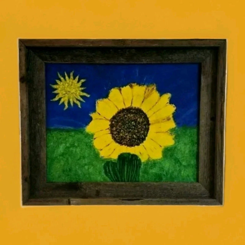Framed acrylic sunflower painting with yellow blooms, blue sky, and green ground