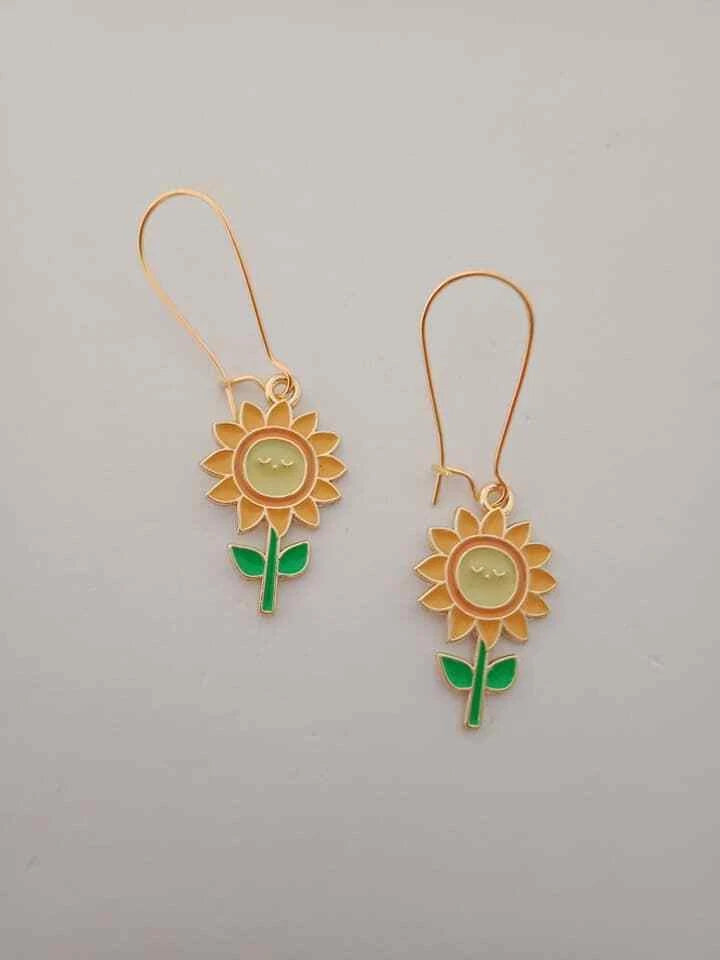 Sunflower charm dangle earrings with gold-tone flower center and green leaf accents