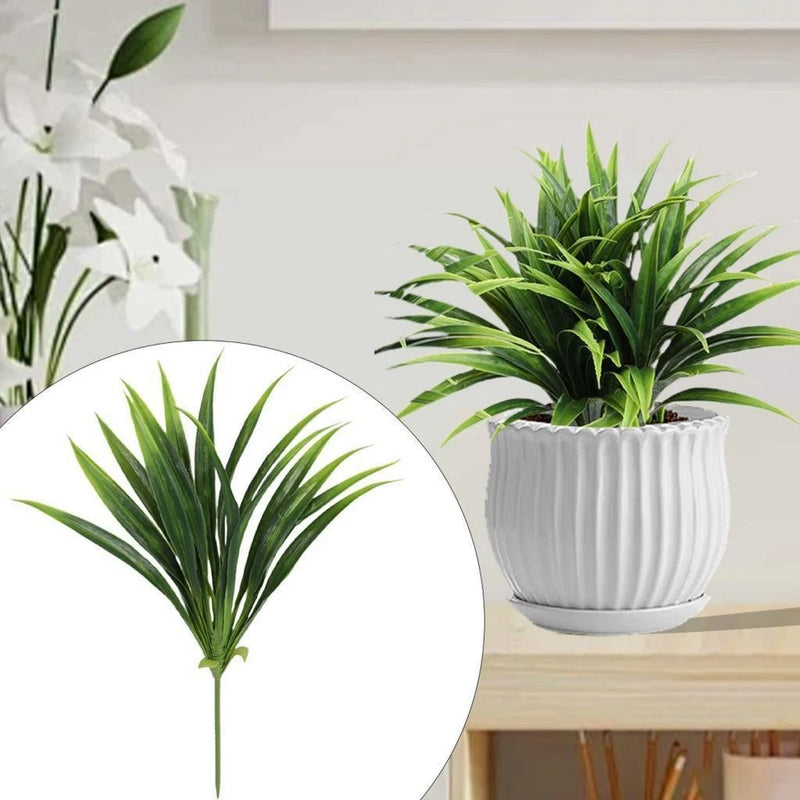 Tall artificial grass plant with green blades in white ridged ceramic pot