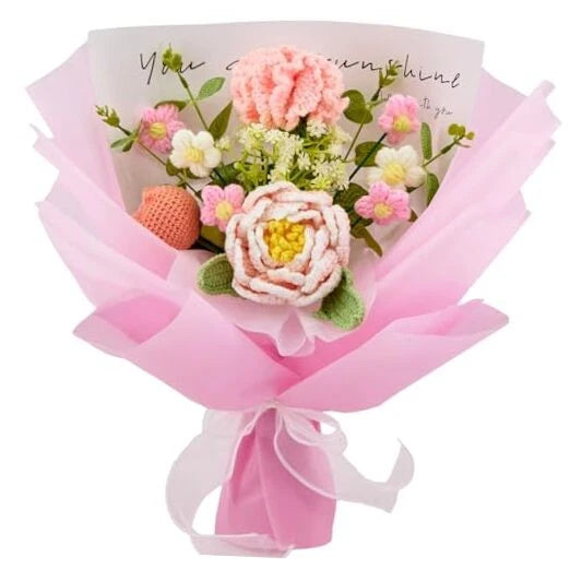 Pink crochet flower bouquet with peony and tulip-style blooms, wrapped in pink tissue.