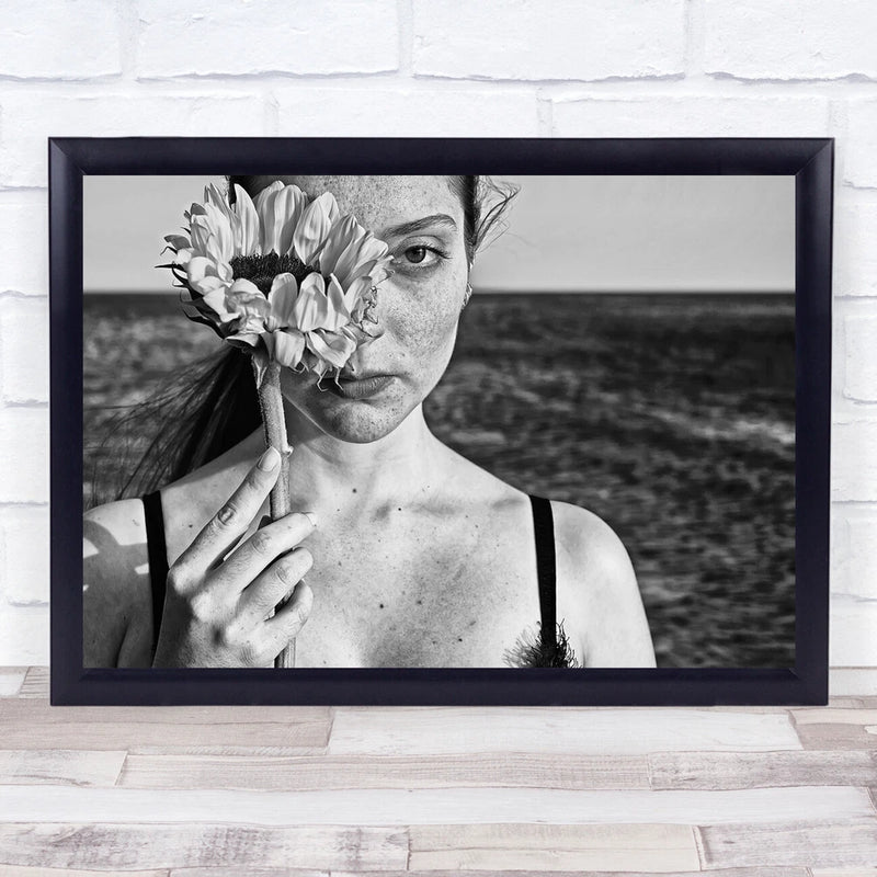 Framed black-and-white portrait print of a freckled woman holding a sunflower