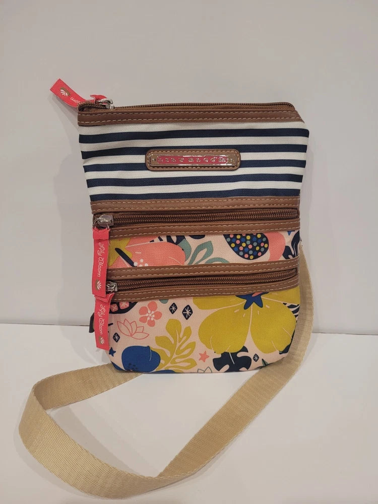Colorful small crossbody satchel with top zipper, striped front pocket, adjustable strap