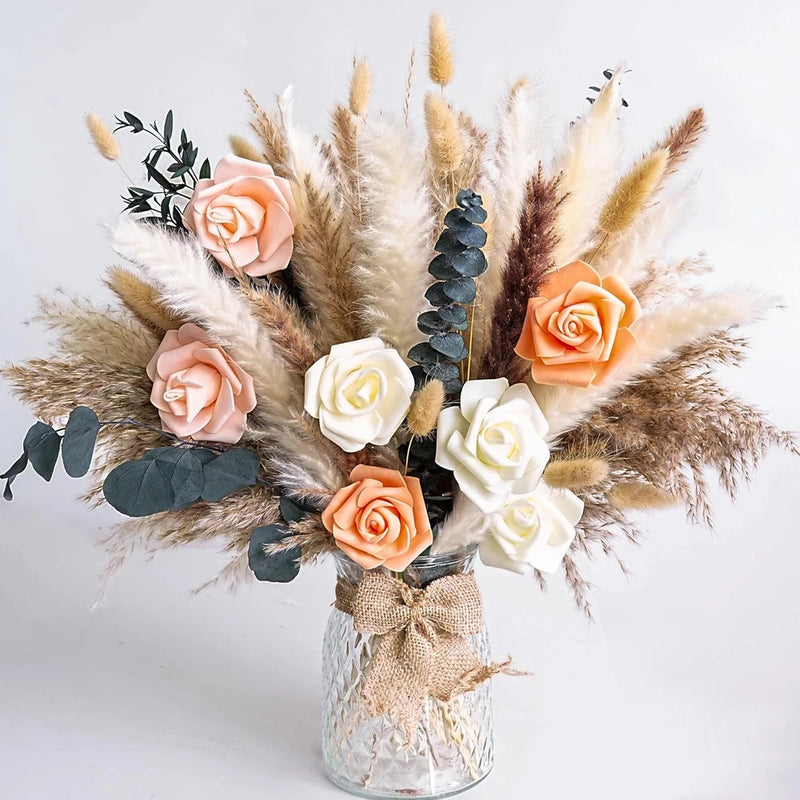 Dried flower bouquet in vase with pampas grass, peach and cream roses, eucalyptus leaves