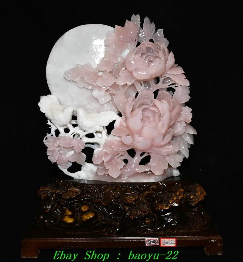 Pink jade peony and bird carving on round white base with dark wooden stand