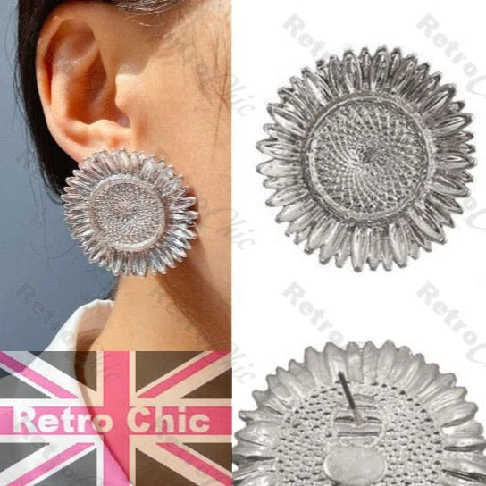 Silver-tone sunflower stud earrings with large textured petals and circular center detail