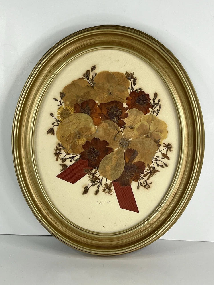 Oval gold wood frame pressed dried flower wall art with tan and burgundy blooms