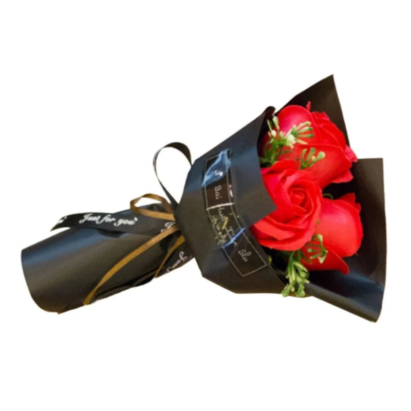 Wrapped gift bouquet with red rose soap flower, ribbon bow, and labeled mini bottles