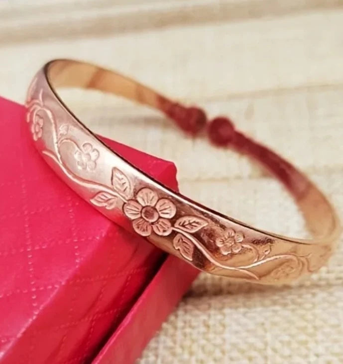 Copper bangle bracelet with openwork rose and vine engraving