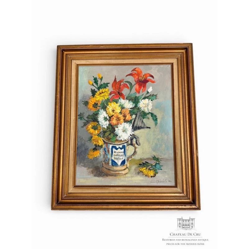 Framed still life oil painting of red lilies and yellow marigolds in a vase