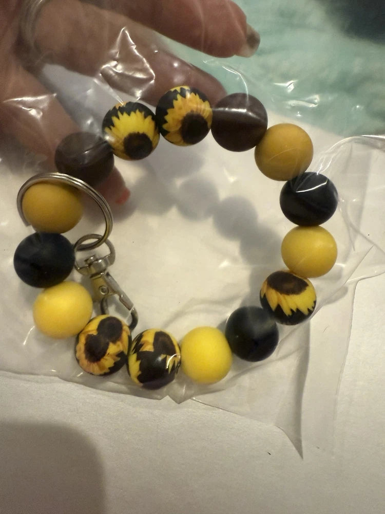 Sunflower bead keychain bracelet with round yellow and black beads, sunflower accents, metal clasp