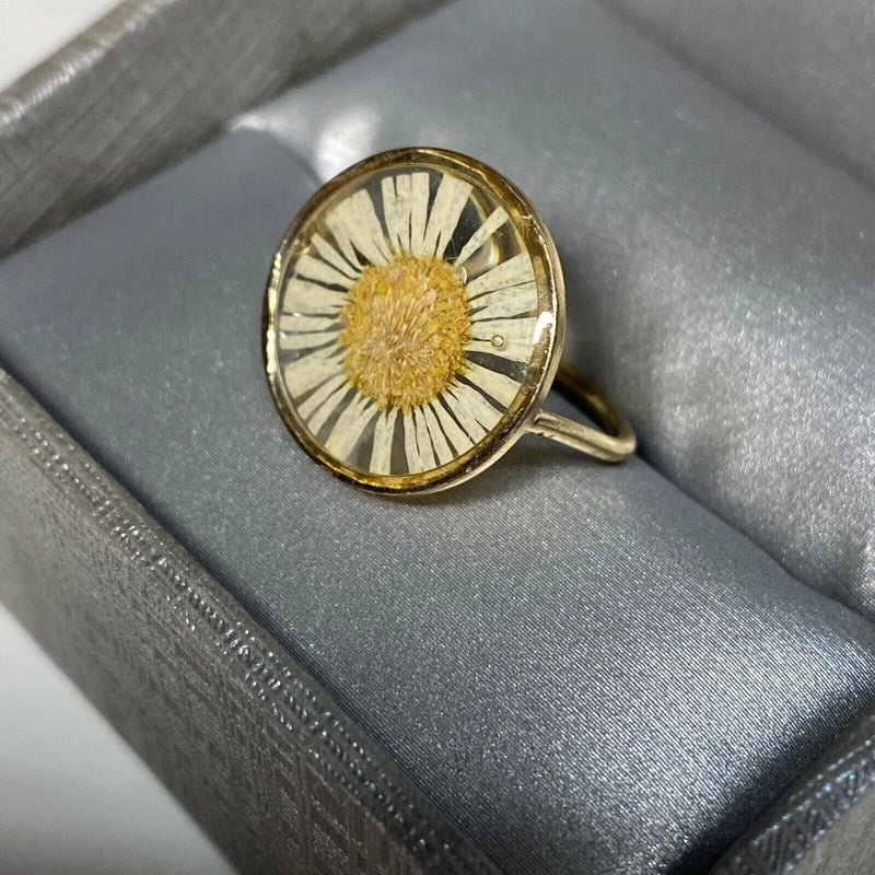 Gold-tone sunflower ring with round glass cabochon and textured center