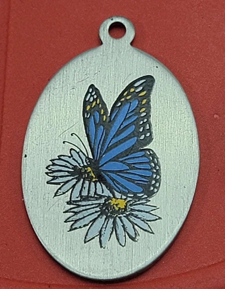 Pewter oval charm pendant with blue butterfly and yellow sunflower flower detail