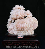 Pink carved jade peony wealth statue with layered blooms on dark base