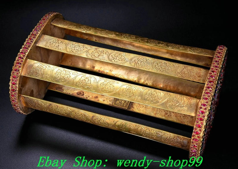 Ornate gold decorative pillow with red gem trim and peony floral design