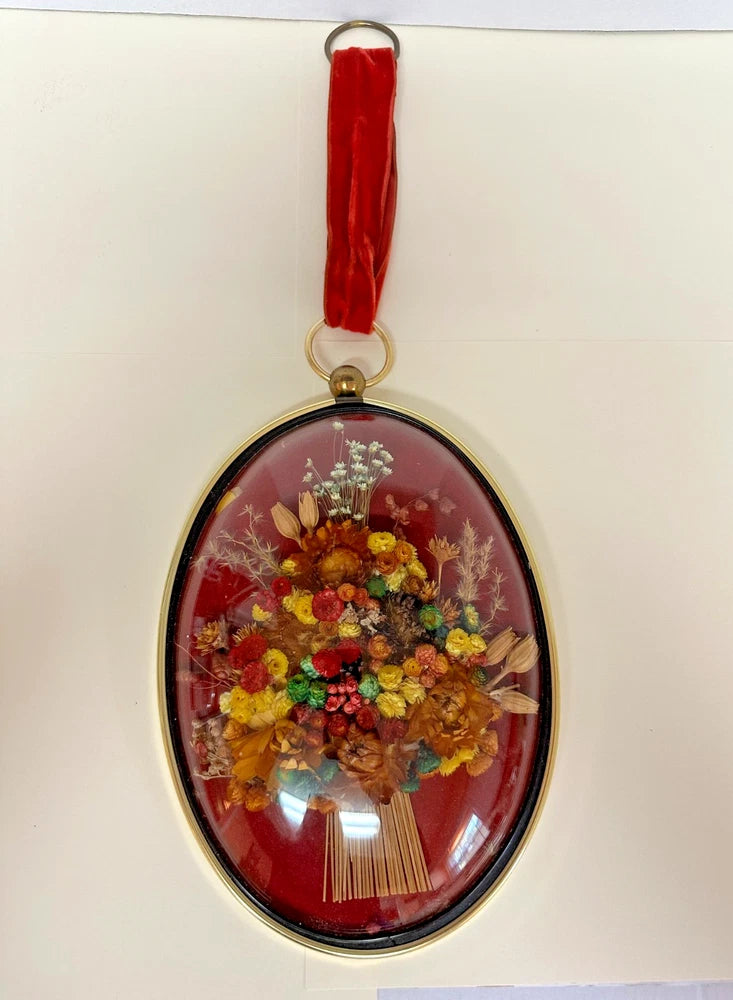 Oval dried flowers wall art in gold dome glass frame with hanging red tassel