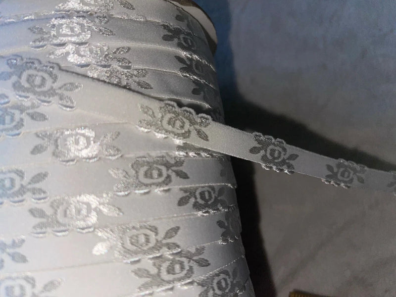 White satin bra strap elastic with embossed rose pattern, shiny 1/2 in width
